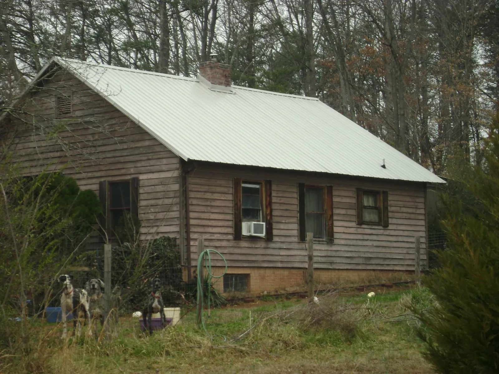 White metal roof on an old wood sided farmhouse, from a Metal Roof Installation job in Pisgah